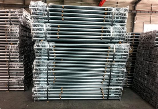 Bundled adjustable steel props stacked in warehouse